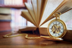 Pocket watch and books in library or study