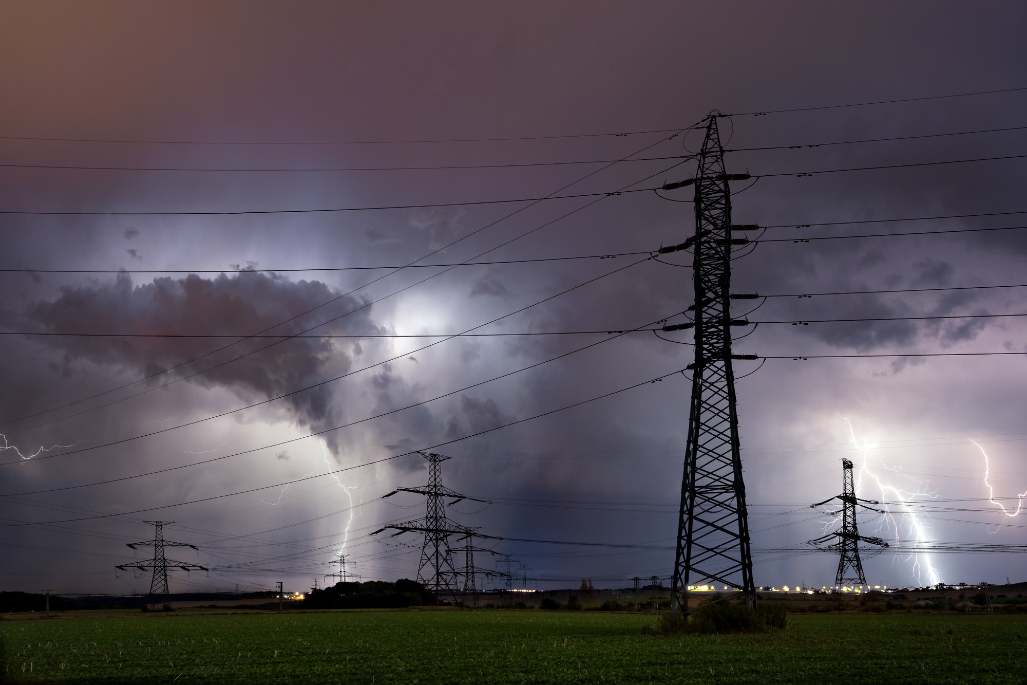 Lightning storm over Prague, Czech republic Silhouette of high voltage electrical mast with lightning storm over Prague, Czech republic