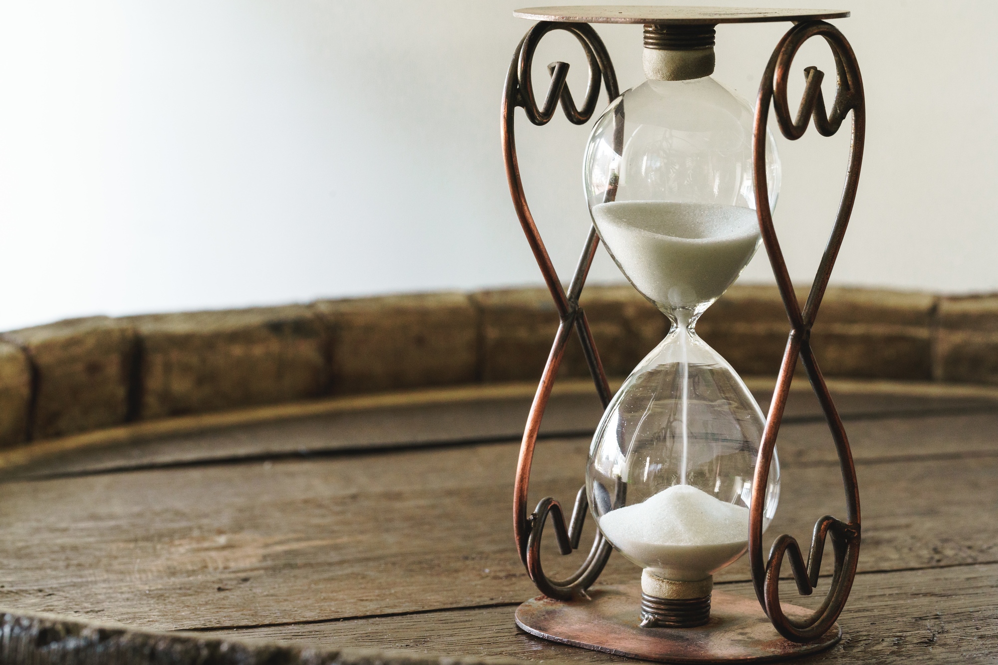 Sandglass on wooden bakground closeup. Time concept Sandglass on wooden bakground close up. Time concept